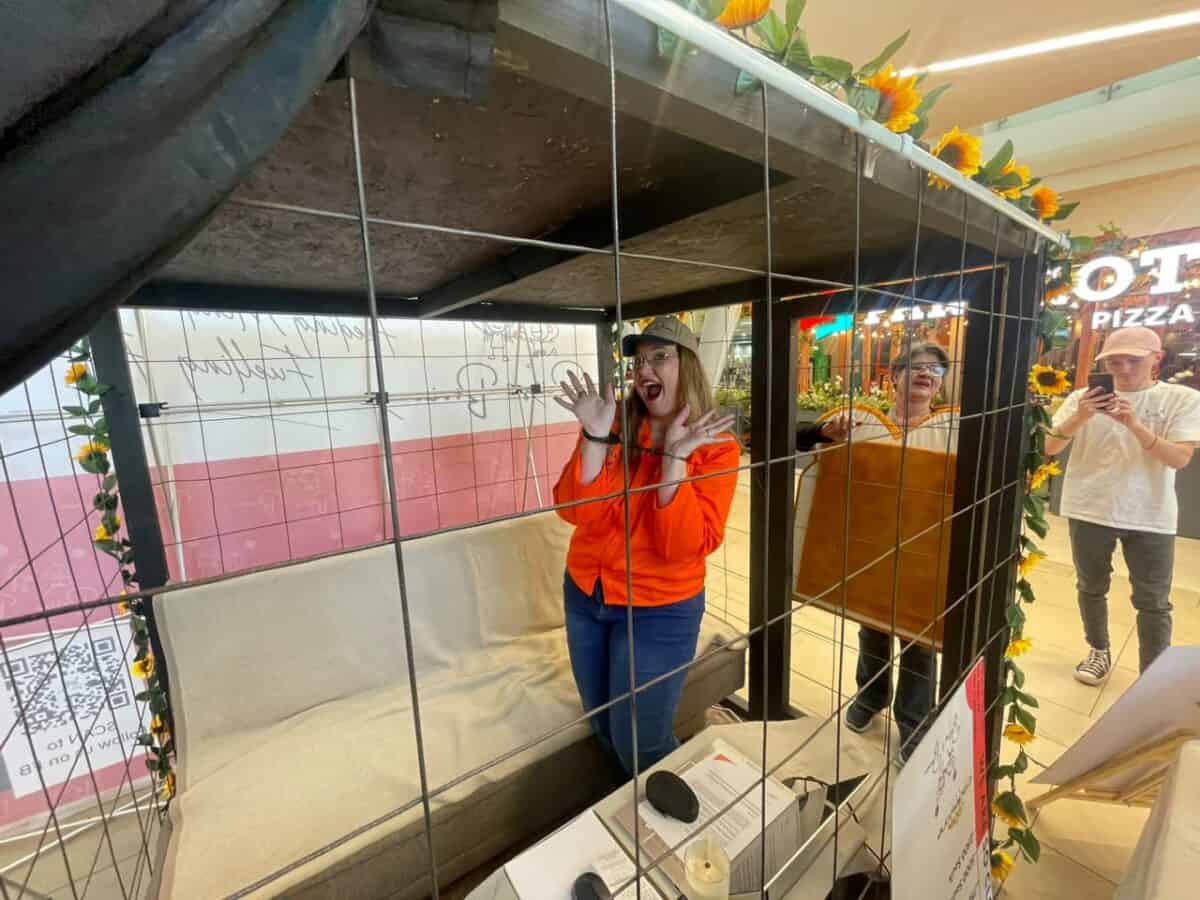 Dominique Tibbles has begun her 67-hour stay in a cage to raise funds to help feed 20 000 people.