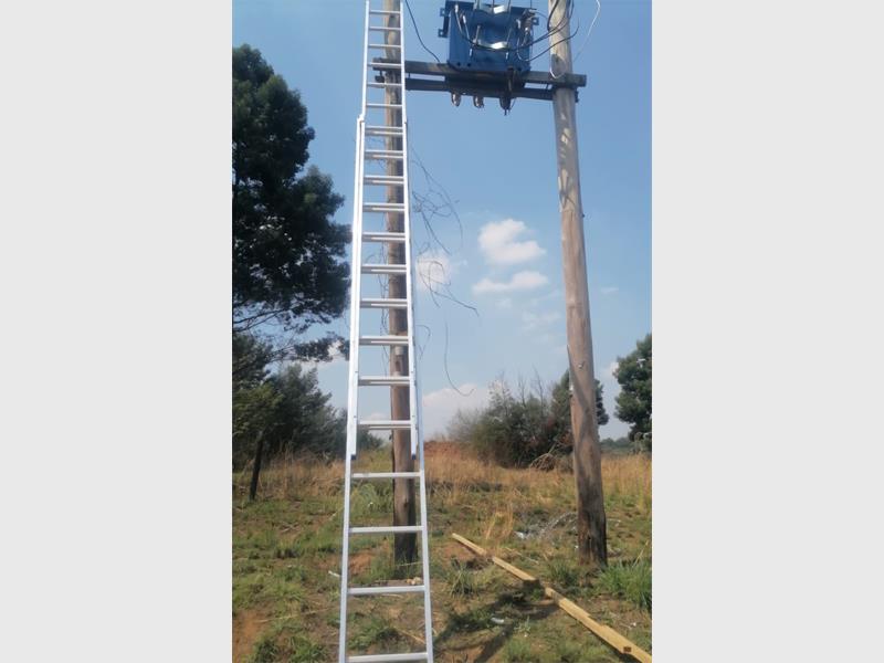 Eskom personnel join law enforcement on the scene after local security dispatches armed response units to catch infrastructure interference in progress.