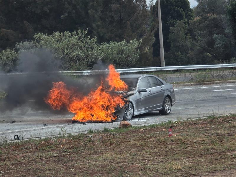 Emergency responders and traffic officials attend to a vehicle blaze on the R28 this morning.