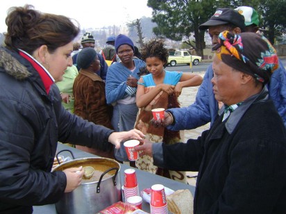 Tannie Lizzie, a resident, helping to dish up soup and bread for residents.