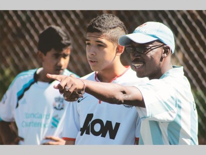 Assistant coach, Bornventore Liphoto discussing tactics with a player.