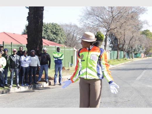 Ouma Morudi demonstrating to the taxi association members how to control traffic. Photo: Sonwabile Antonie