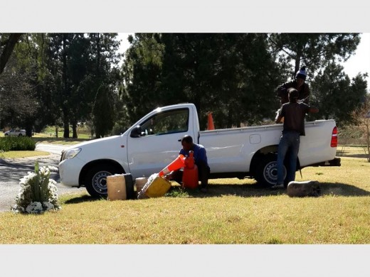 A traffic cone being used to fill water cans.