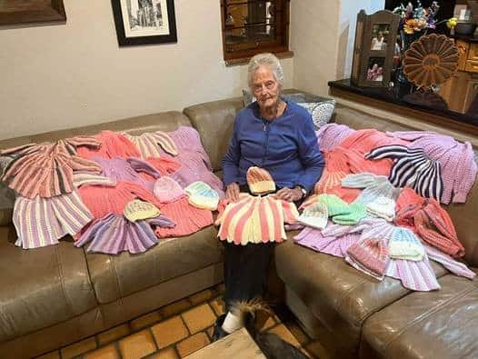 Pam Saunders (92) has, over the years, knitted more than a thousand jerseys and beanies.