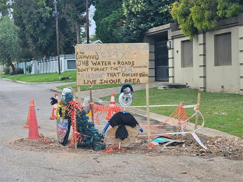 Residents fed up with years old potholes take festive action, while the ward councillor says the blame is being pinned on the wrong office.