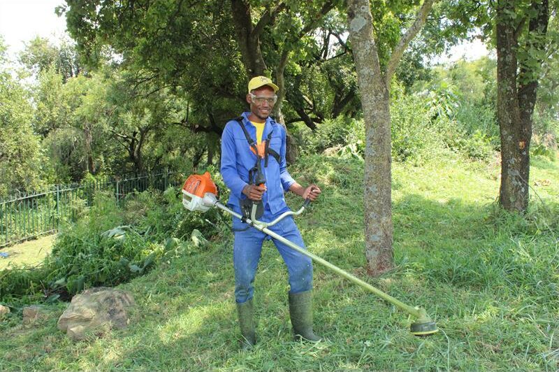The team rolled up their sleeves and worked in the hot sun to restore the area's beauty and improve visibility.