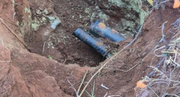 Electricity cables that has ben stolen. A hole is dug in the ground.