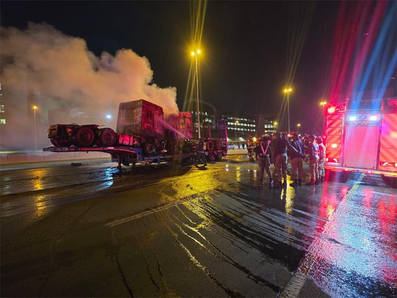 Emergency services unite to contain a major blaze and manage traffic on a key national route.