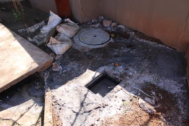 A Florida Hills homeowner has taken matters into her own hands by building a barrier after recurring sewer blockages and a nearby sinkhole left her property flooded with raw effluent.