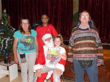 One of the benefiting families, with Santa Clause, at the handover.