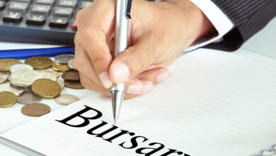 Hand with pen pointing to Bursary word on the paper