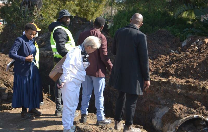 Unexpected underground infrastructure has delayed the Illiondale sinkhole repairs, pushing the completion date to late August as engineers revise designs to safely reroute stormwater flow into the wetland.