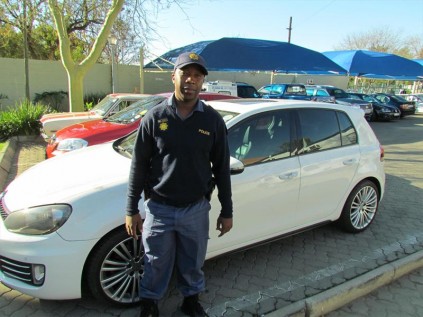 GOOD WORK: Constable Tenyike Johannas Matjeke of the Douglasdale Police Station at one of the vehicle's recovered.