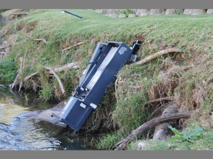 THE AFTERMATH: The Barron's cigarette machine lies in the Jukskei River after the robbery.