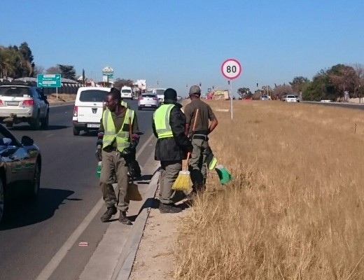 Workers clean up the area around William Nicol Drive.