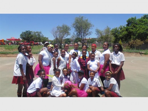 Some of the women from Douglasdale Police Station with the girls from Witkoppen School get ready for their first netball match of the day.