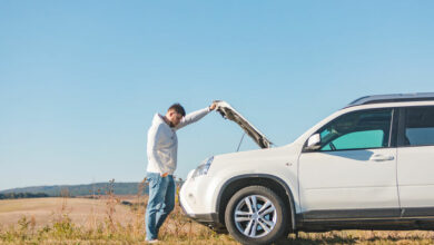 man standing near car with opened hood on sunset