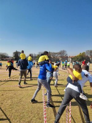 Some parents and learners have fun at Junior Colleges Gardens.