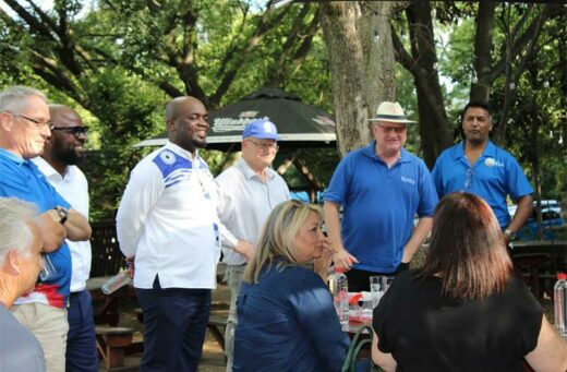 Solly Msimanga surrounded by Fourways councillours, addresses residents about their plans to resolve the squatter camps in Lonehill.
