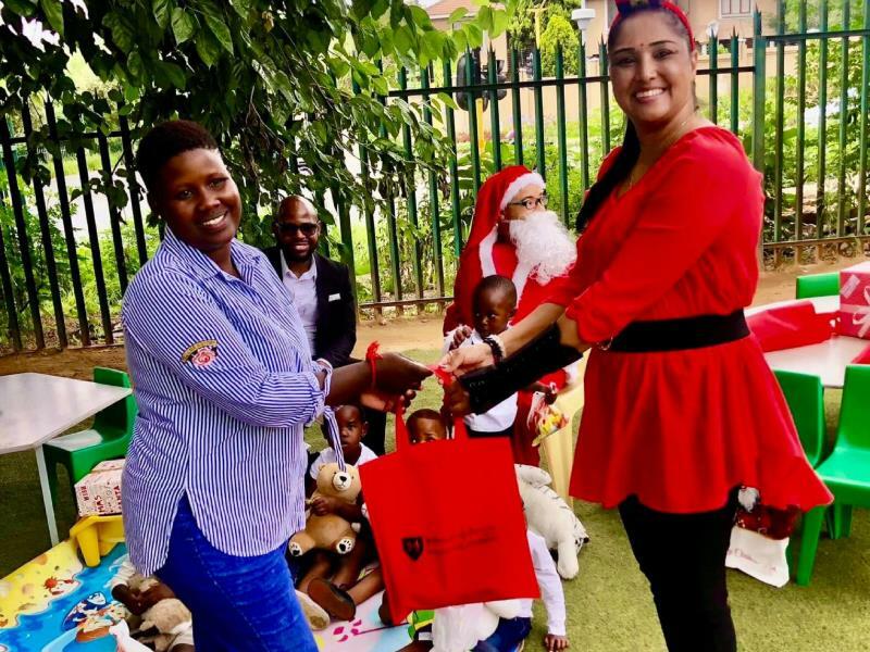 Puleng Chabide alongside Michelle Chelliah-Singh from Love Light Care Foundation at a Christmas function.