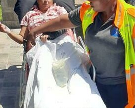 Michelle Singh receives medical help shortly after being shot by a rubber bullet.
