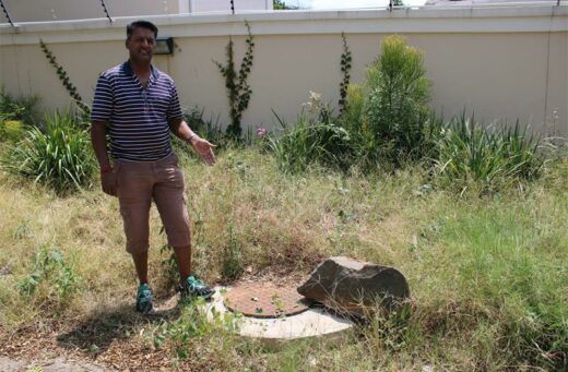 Ward councillor Vino Reddy pointing at one of the inlets installed by the JRA.