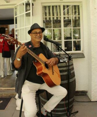 Jacques Lagesse, the musician everyone dances to is happy with his guitar.