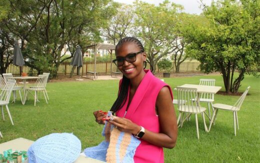 Lindo Mbalati knits her first blanket she started a few days ago.