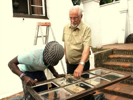 Tony Gietzman and one of his team members repair a broken window.