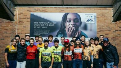 Caitlin and Steve Mee pictured in their mixed team race leader jerseys alongside SA’s top professional cyclists, on day two of the KAP sani2c Race.