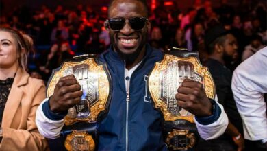 Igeu Kabesa at EFC 114 with his two belts.