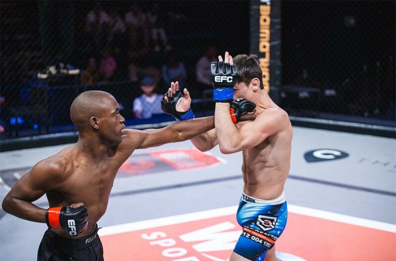 Tebatso Molele throws a left straight towards Willie van Rooyen.