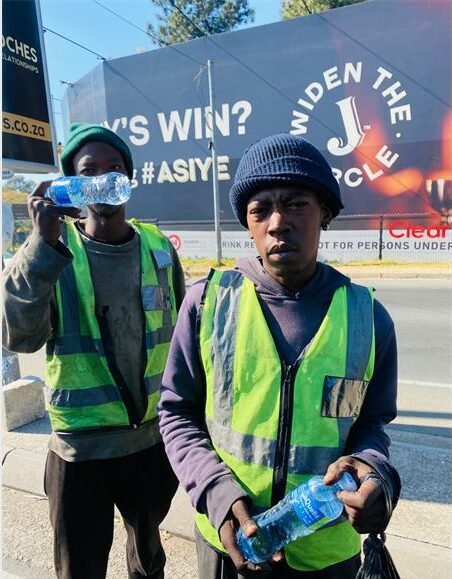 Lebogang Modise and Adam Nkosi at the intersection where they play informal pointsmen on July 7, 2024. Photo: Ayanda Ntshingila