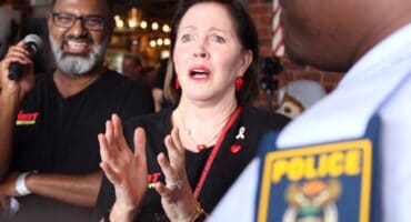Caroline Steyn, founder of 67 Blankets for Madiba gets playfully 'arrested' by Douglasdale police to raise funds during a charity event at Broadacres Shopping Centre on October 30, 2025. Photo: Ditiro Masuku