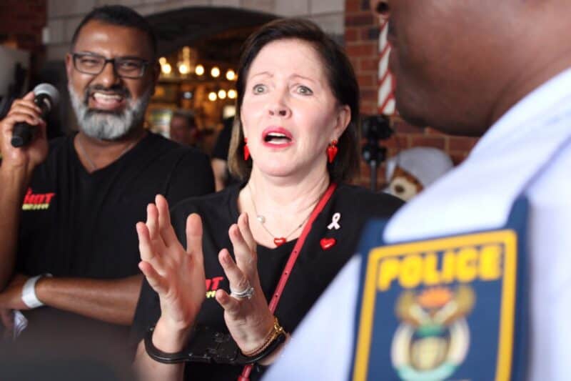 Caroline Steyn, founder of 67 Blankets for Madiba gets playfully 'arrested' by Douglasdale police to raise funds during a charity event at Broadacres Shopping Centre on October 30, 2025. Photo: Ditiro Masuku