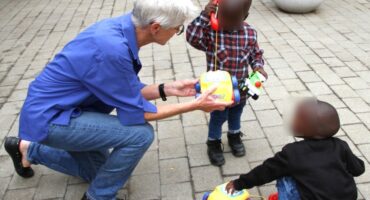 A Rotary Club member hands out toys to children as part of the annual Fourways Rotary Club Christmas toy drive. Photo: Supplied