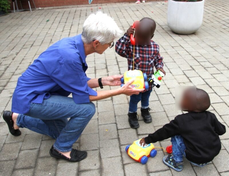 A Rotary Club member hands out toys to children as part of the annual Fourways Rotary Club Christmas toy drive. Photo: Supplied