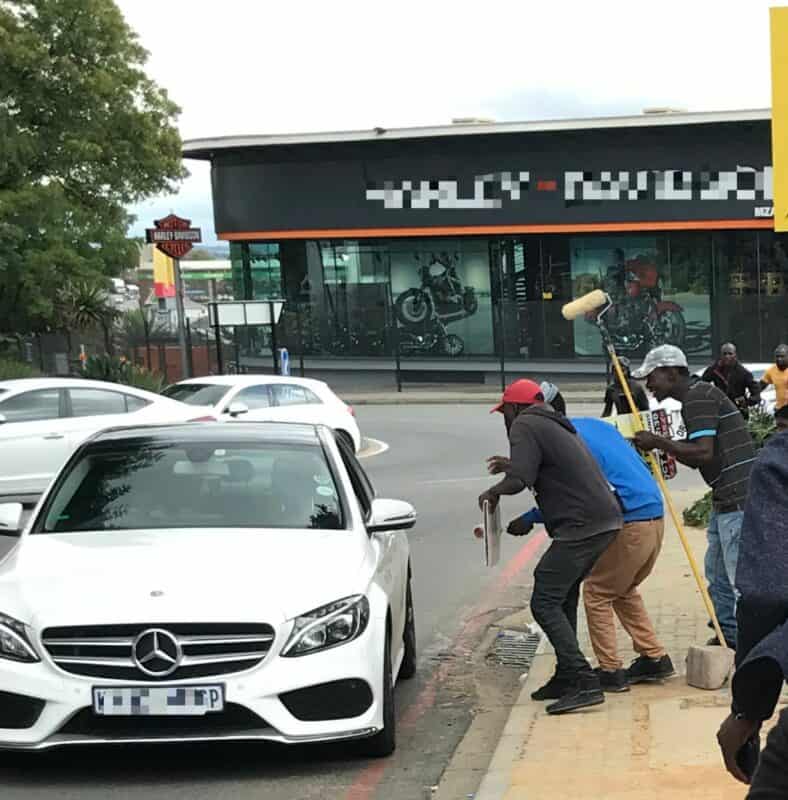 One of the job seekers, Simba, returns daily to Sunrise Boulevard with a handmade placard, seeking work on his own terms, preferring street deals over traditional employment.