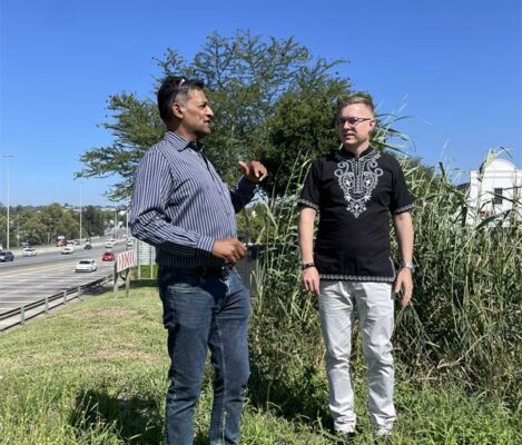 Ward 93 councillor Vino Reddy and Graham Gerrard stand near the suspected underground spring and culvert system across the freeway, where water feeds into a wetland before making its way toward Witkoppen Road. Photo: Ayanda Ntshingila