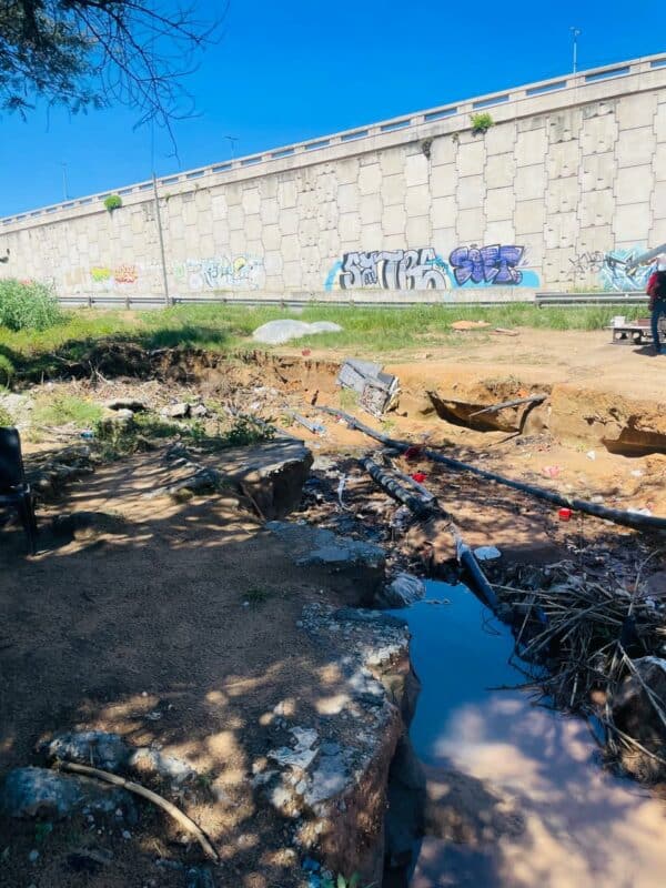 Exposed pipes, visible cables and ongoing flooding at a major Fourways corner have raised safety concerns, with officials saying the issue has persisted for years.