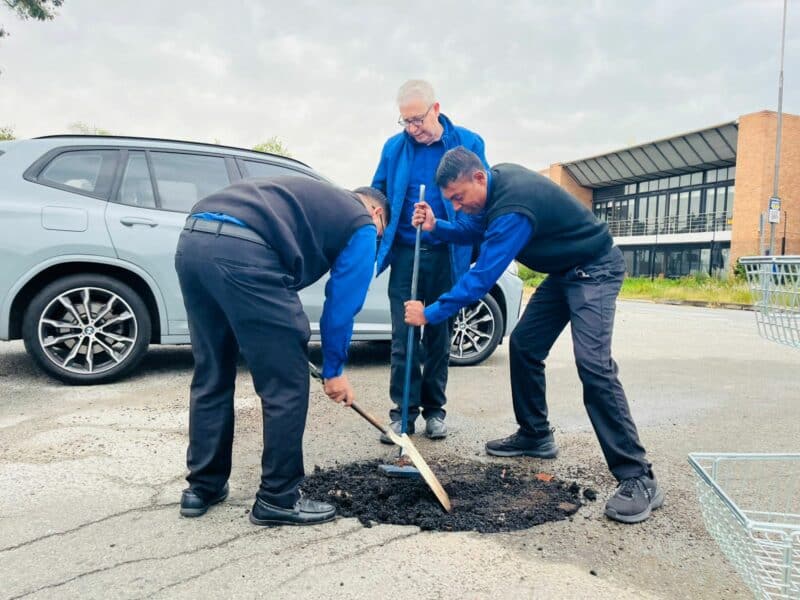 The home appliances, electronics, and home furnishings store celebrated the day by repairing potholes and cleaning up surrounding streets as growing frustration over deteriorating road conditions pushed them to act.
