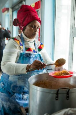 A volunteer helps dish up one of the 16 million meals raised by Food Lover's over hunger month. Photo: Supplied