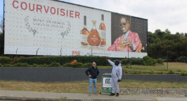Maj Saffari and Rufas Mazwazi by the large alcohol billboard near the Cedar Road and Riverside Drive intersection opposite Steyn City School on June 4, 2026. Photo: Ayanda Ntshingila
