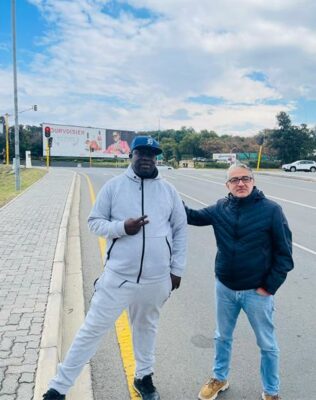 Maj Saffari and Rufas Mazwazi by the large alcohol billboard near the Cedar Road and Riverside Drive intersection opposite Steyn City School on June 4, 2026. Photo: Ayanda Ntshingila