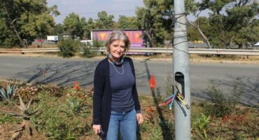 Resident Tracy Kendey stands by the exposed cables of the streetlights along Maxwell Drive on June 25, 2026. Photo: Ayanda Ntshingila