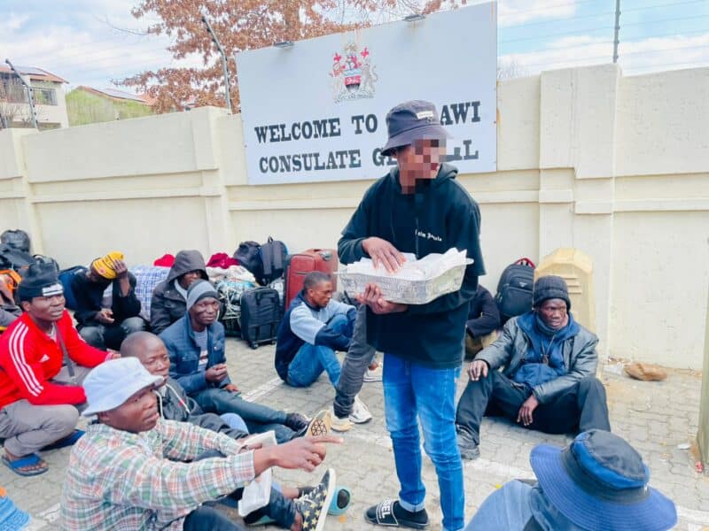 Fleeing job loss and instability, Haroon Yusuf, 22, joins hundreds waiting outside the Malawi Consulate Centre in the cold, forced to leave their interrupted lives behind.