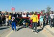 Young protesters march along Winnie Mandela Drive in Diepsloot, chanting ‘maba hambe’ meaning ‘they must go’ as they carry the South African flag. Photo: Ditiro Masuku