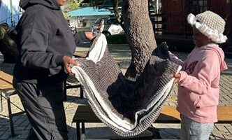 Xolelani Ngwenya and her daughter Penelope Ngwenya receive a blanket to keep warm on June 08, 2026 . Photo: Cleopatra Fothane.