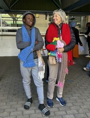 Success Rantho enjoys his handmade scarf from Denise Brennon, from Cedar Lakes Estate KnitWits, during the Mandela Day celebration in July 16, 2026. Photo: Ayanda Ntshingila