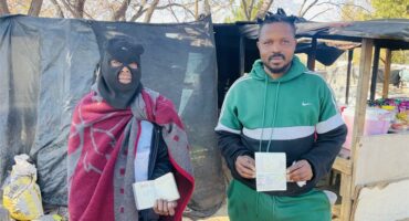 Ginger Park residents Tello Shadrake and Lililoro Pitsho show their passports amid reports of planned anti-migration marches. Photo: Ayanda Ntshingila